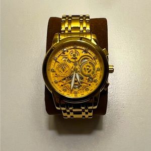 Gold watch with exposed gears design
